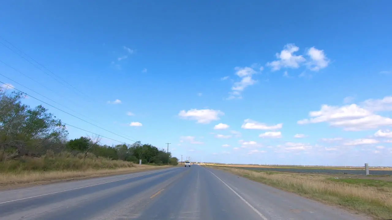 POV driving through rural Rio Grande Valley in southern Texas past vegetable fields