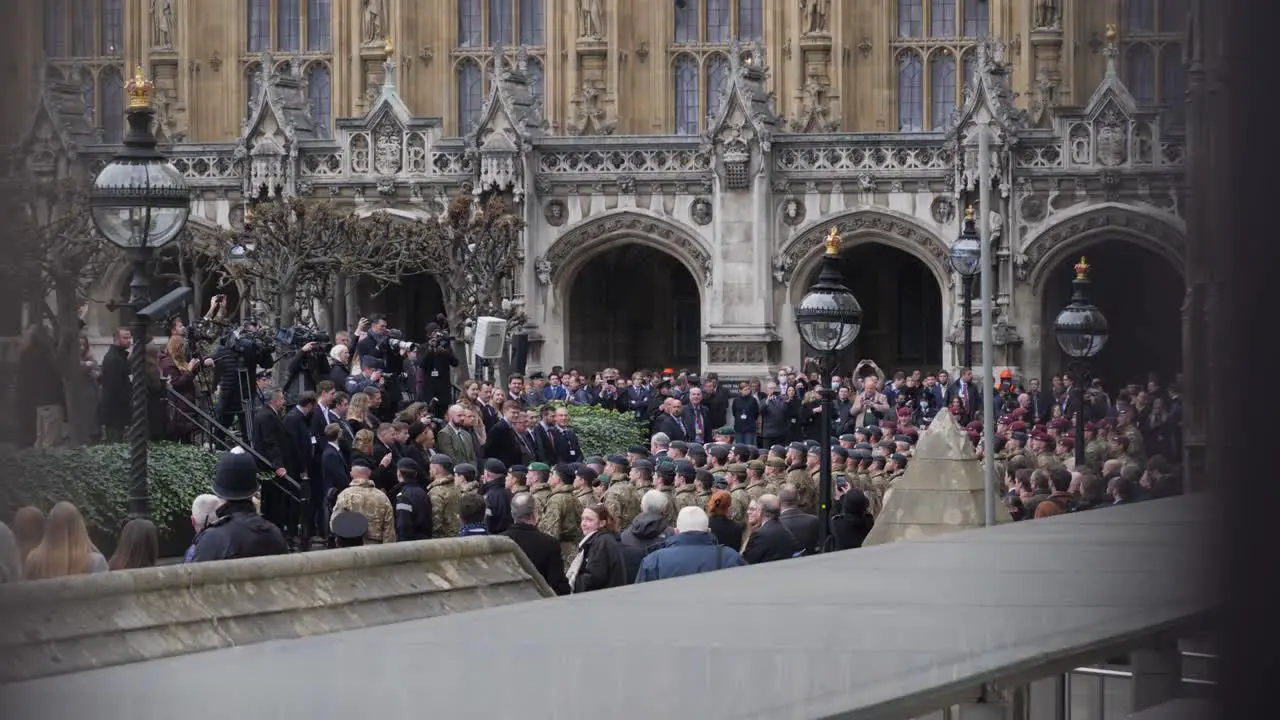 Many soldiers in westminster yard through metal fence