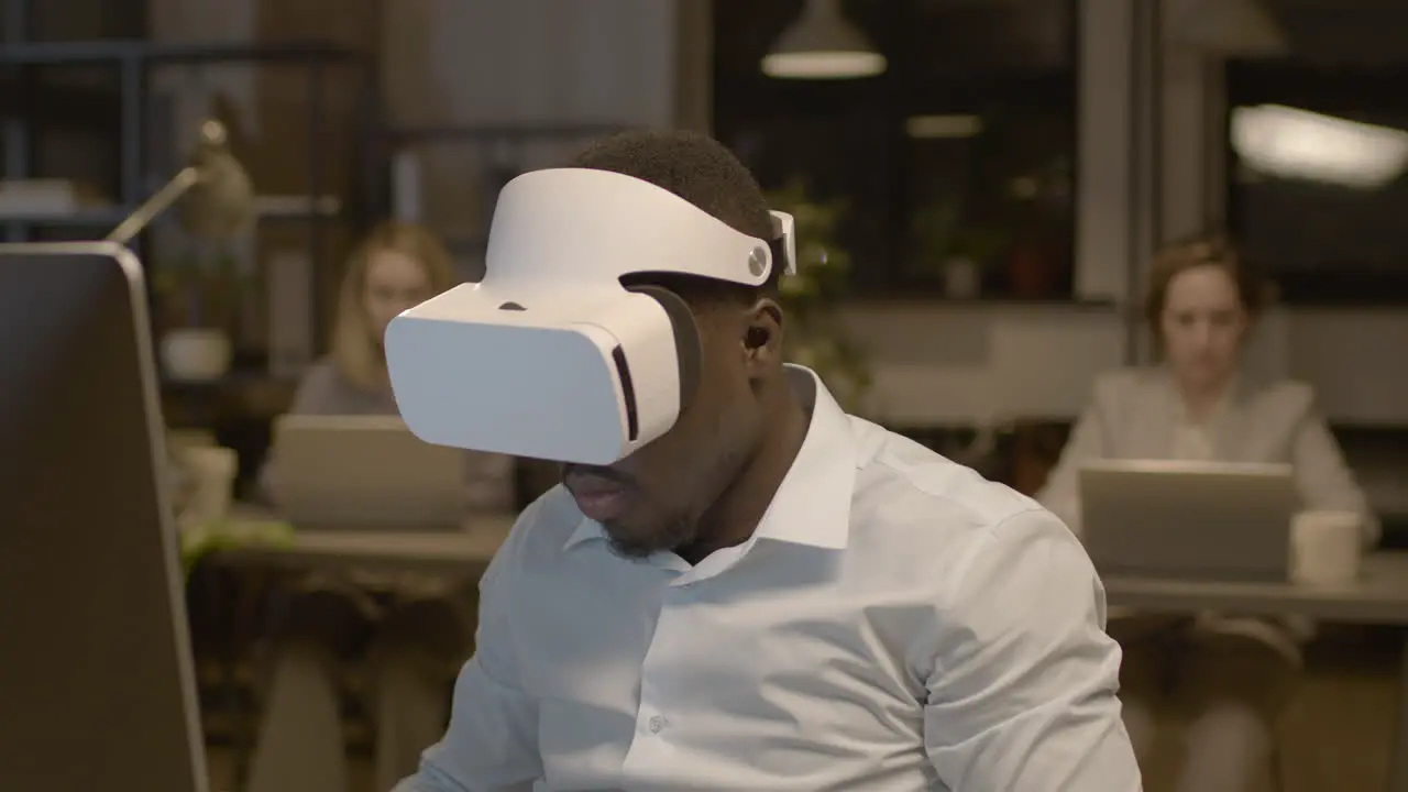 Close Up View Of American Man Sitting At Desk In The Office Wearing Virtual Reality Glasses 1