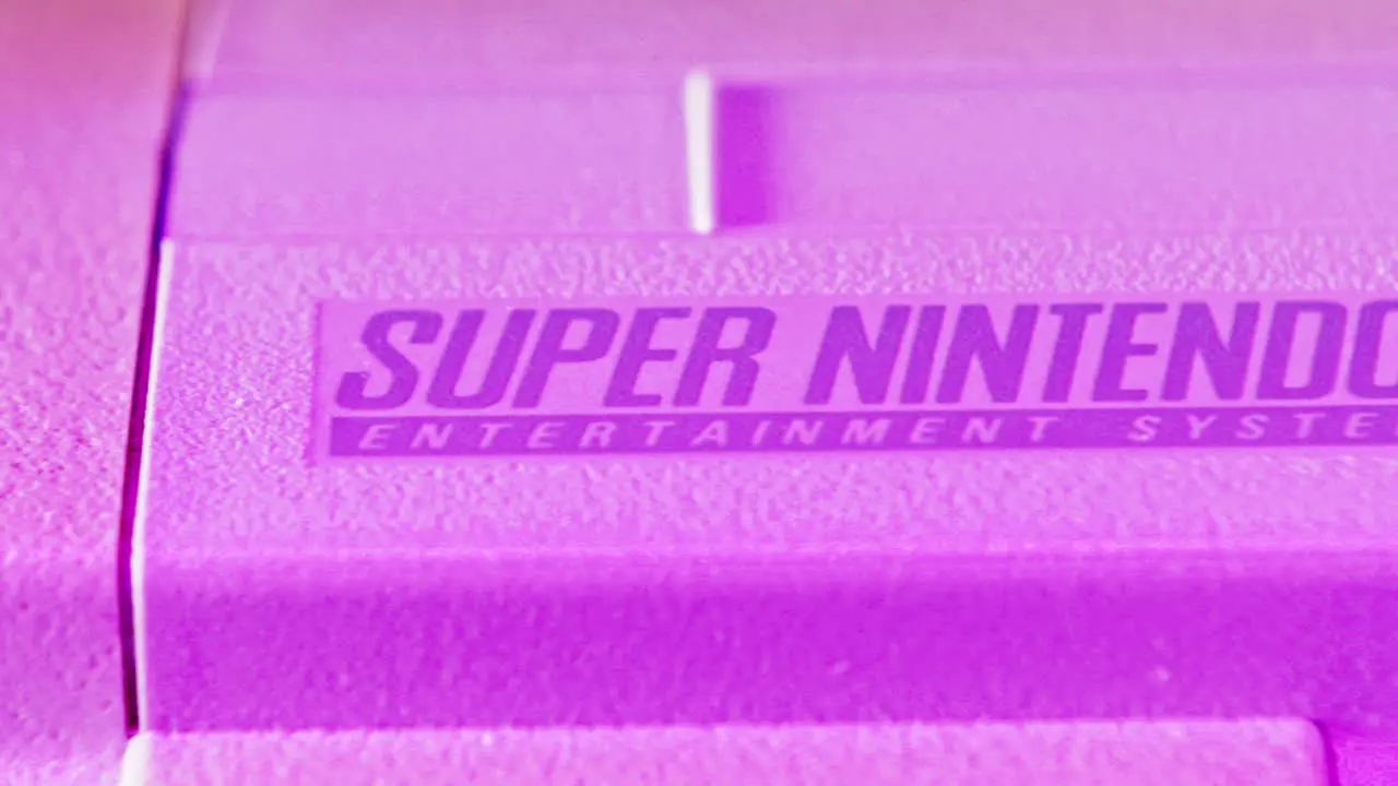 Logo on Vintage Super Nintendo Console in Purple Light SLIDE LEFT