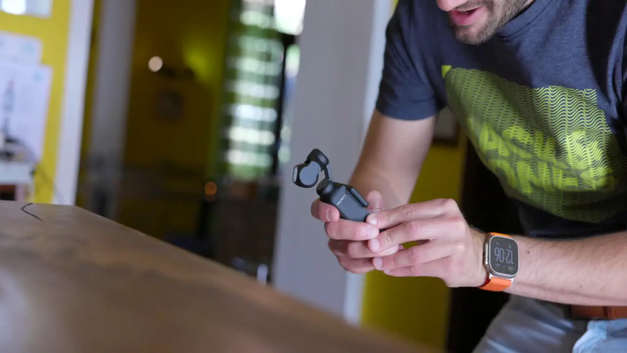 Freelancer Seen Using DJI Osmo Pocket 3 Indoors Filming Wooden Table