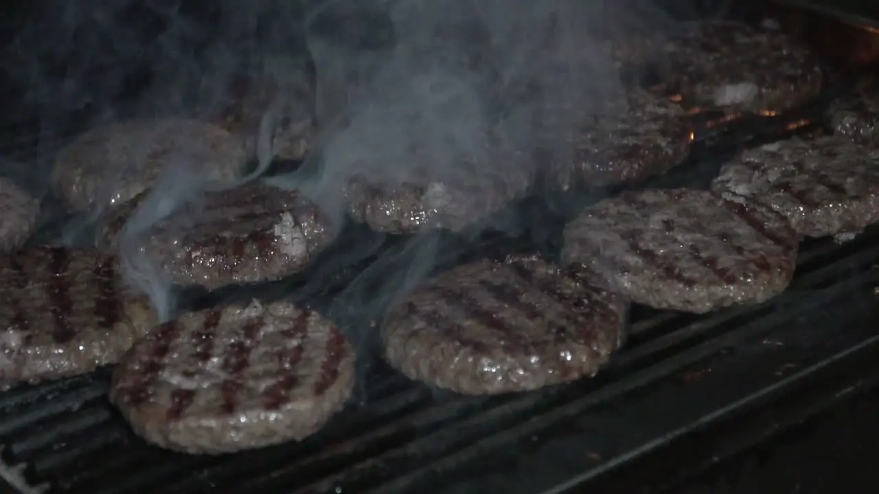 burger on grill slow motion with fire and smoke