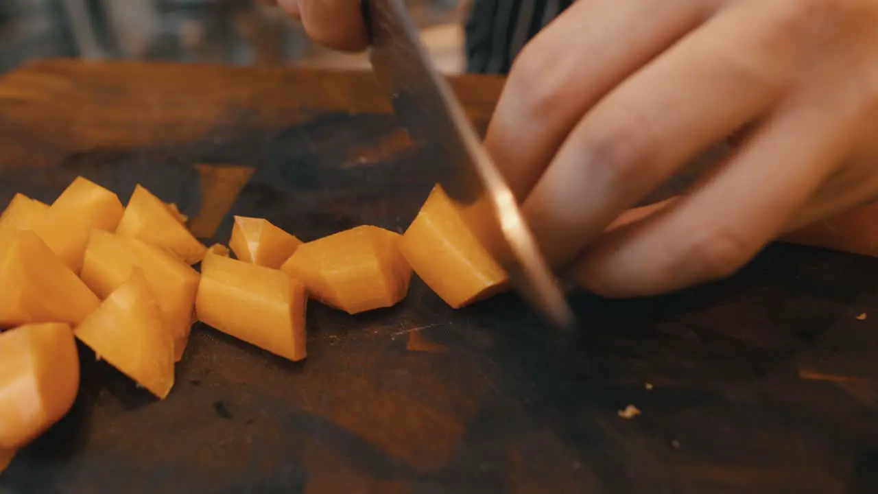 Chopping carrots on wooden board