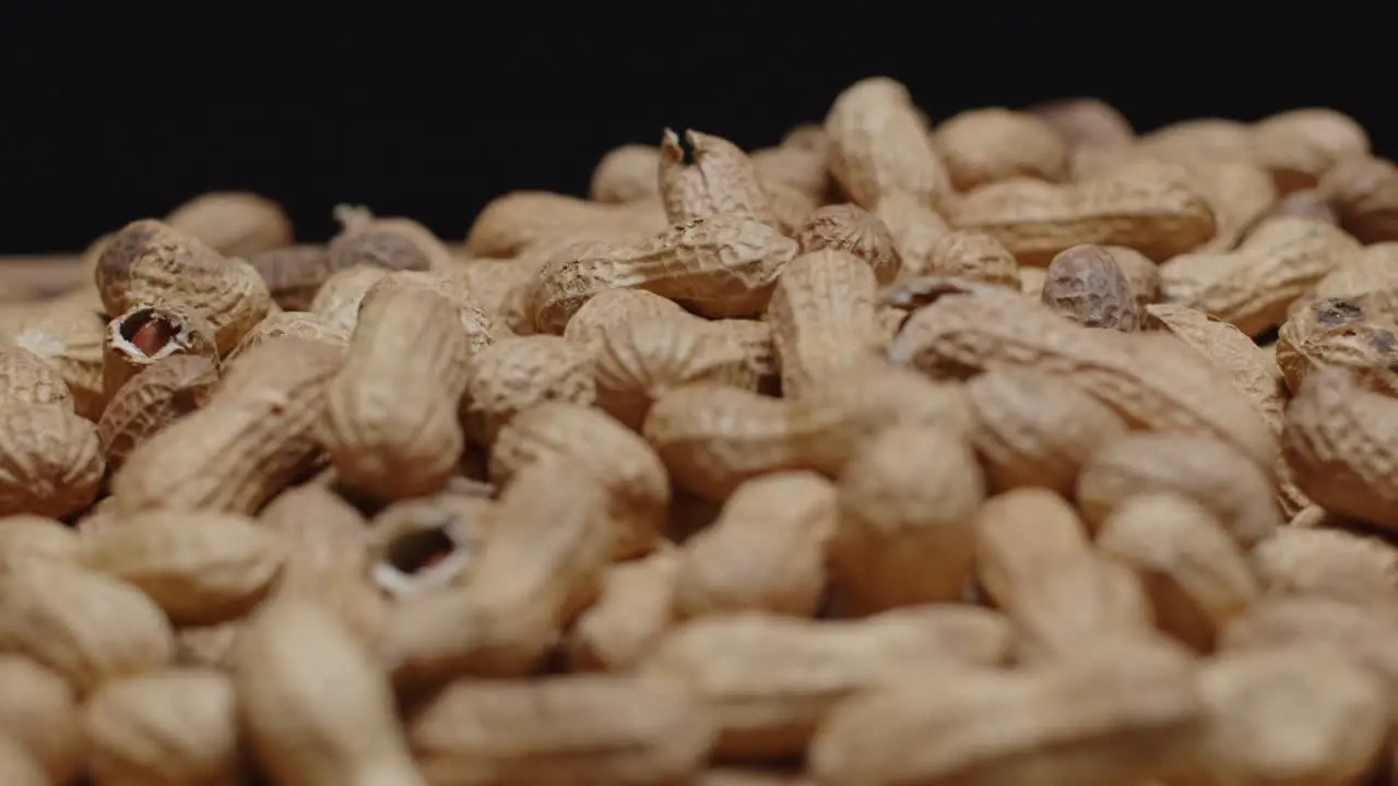 Spinning wide angle of a pile of peanuts with a black background