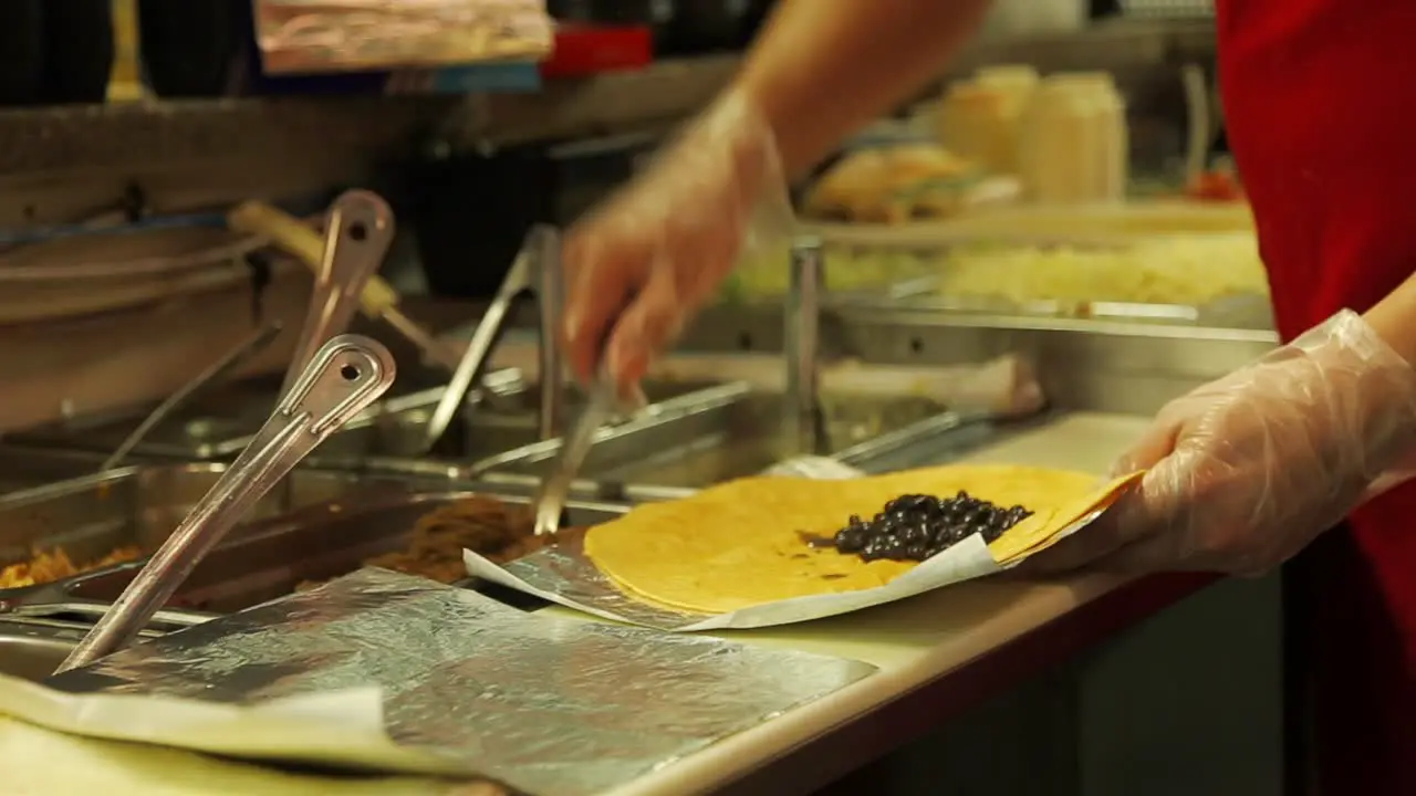 Taco being made; food coupled onto tortilla