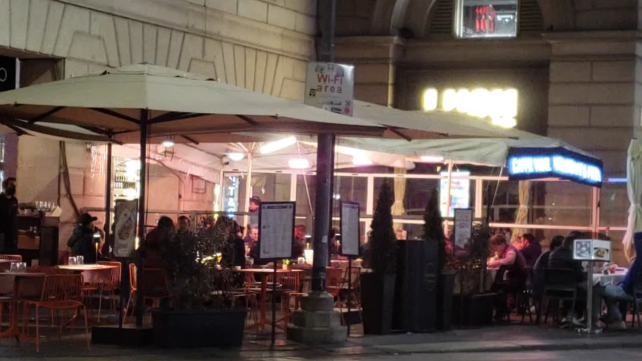 Restaurant tables outside at night on sidewalk in Europe New York