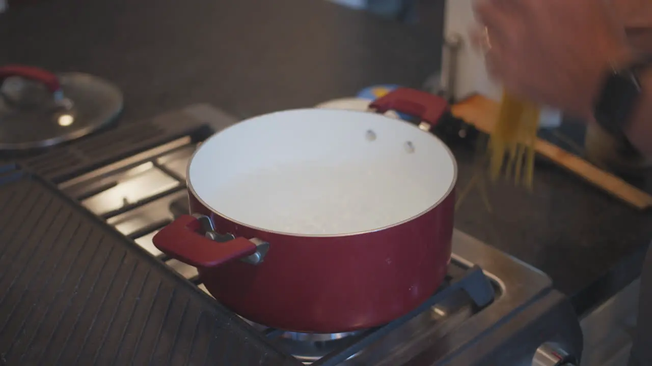 Adding spaghetti to boiling water