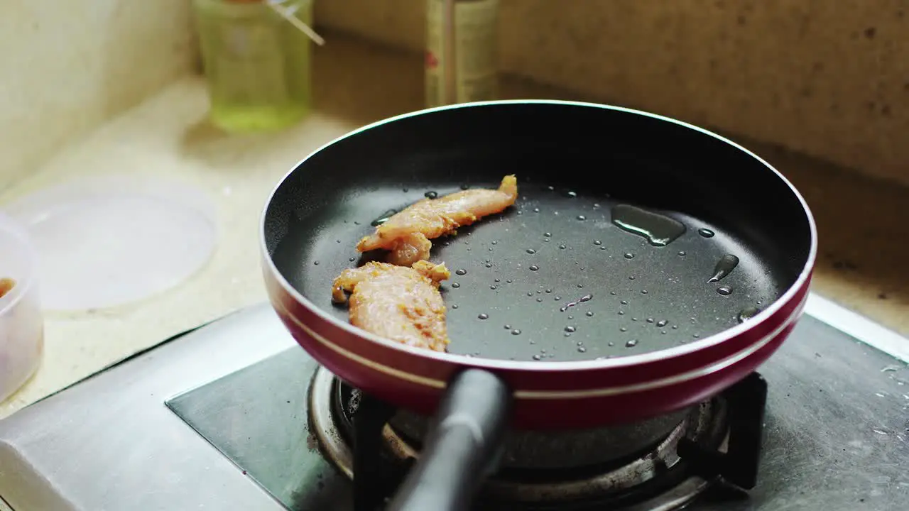 Frying tasty garlic chicken fillet for lunch