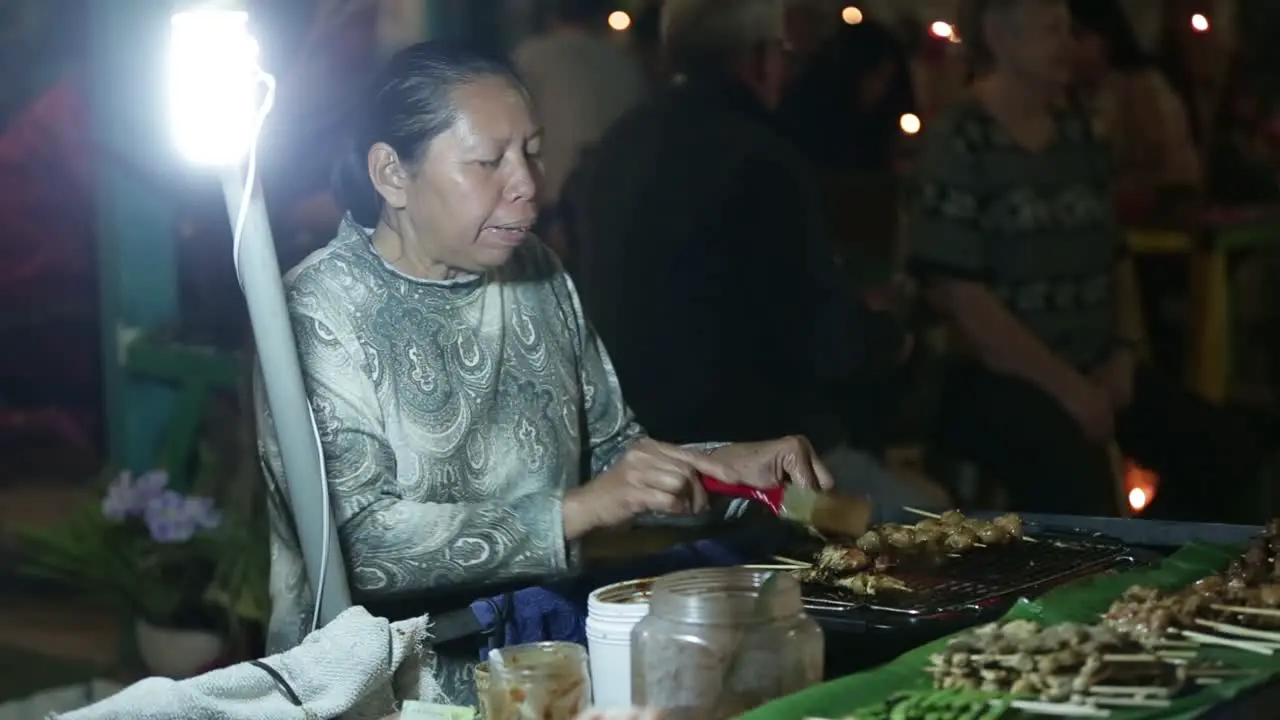 Street Vendor Selling Differnt Kind of Local Barbecue Skewers at Night Market