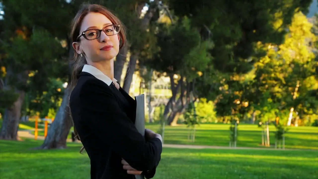 Attractive caucasian business woman looks at the camera with an expression of pride and confidence