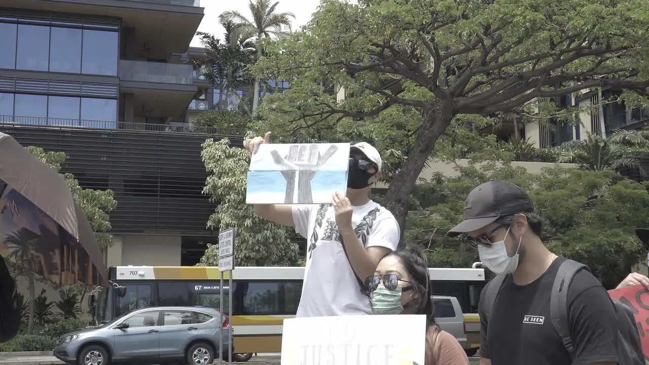 Man holding up a shaka black lives matter sign at a black lives matter protest