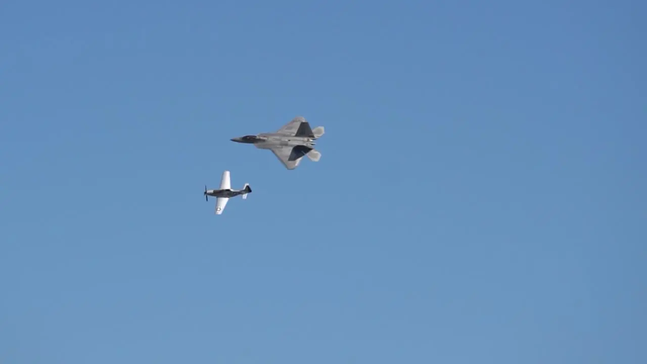 In a link from past to present the United States P51 Mustang and the F-22 Raptor advanced fighter aircraft do a legacy fly by to honor the changes and growth of American fighter aircraft