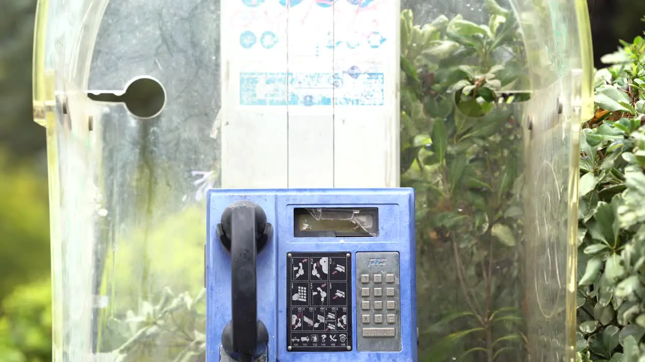 Haifa Israel jan 13 2023 old broken payphone blue pay phone that belongs to Bezeq telecommunications company