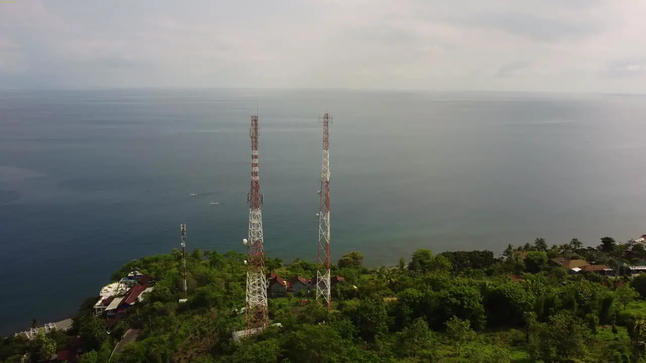 two aerial 5g telecom tower data internet wireless gsm gps 4g social media with ocean view