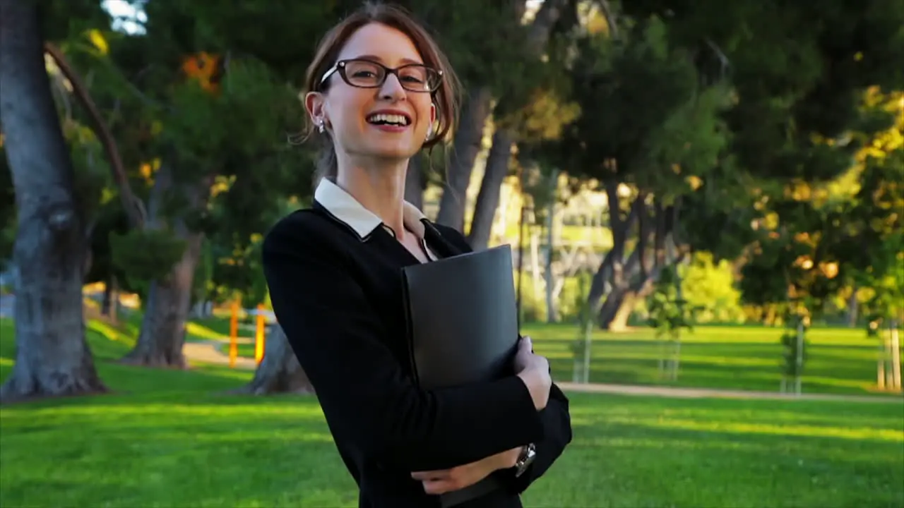 Attractive caucasian business woman looks at the camera with a huge smile and laugh