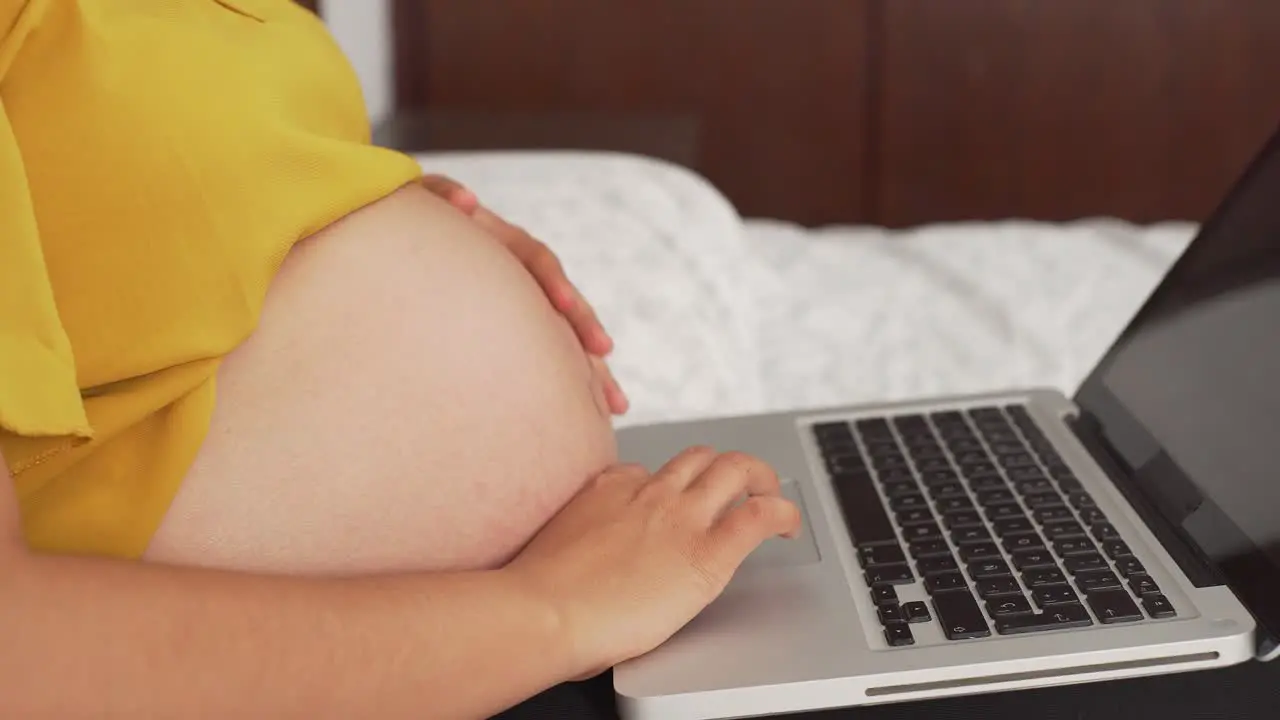 a young latinx woman working on laptop