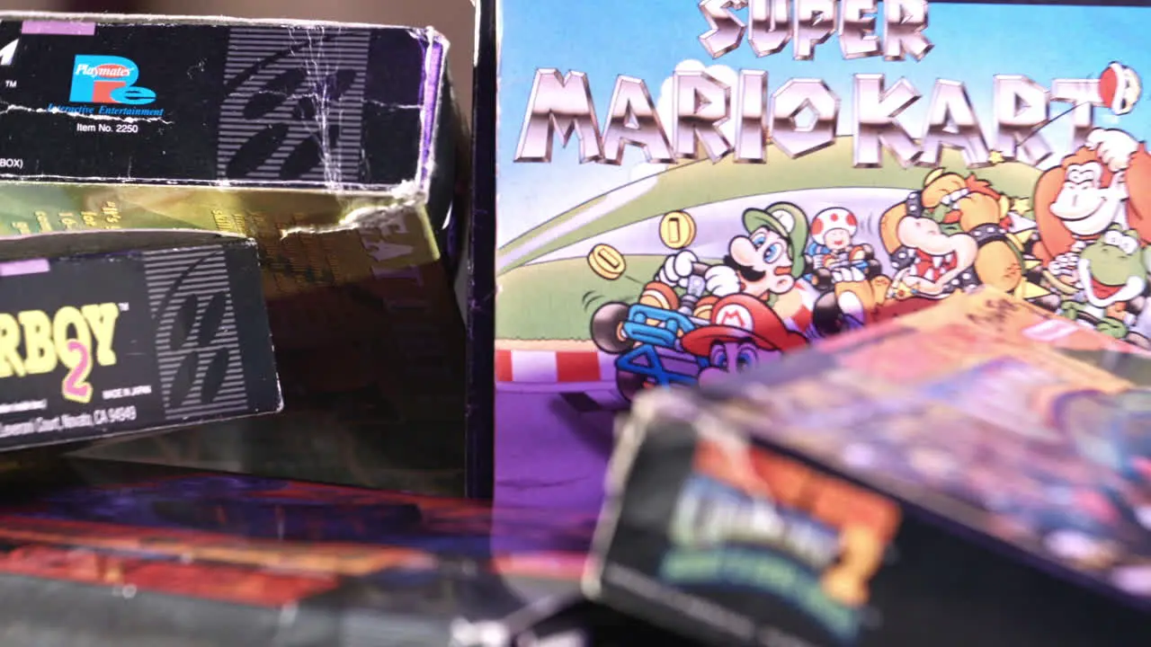 Vintage Super Mario Kart Box with Other Games Surrounding in Purple Light SLIDE LEFT