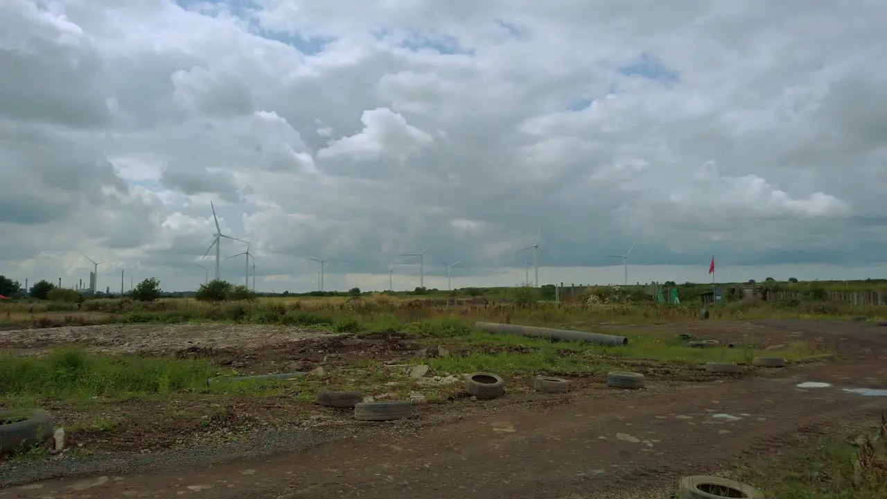 Wind turbines on grey cloudscape in UK in wasteland setting