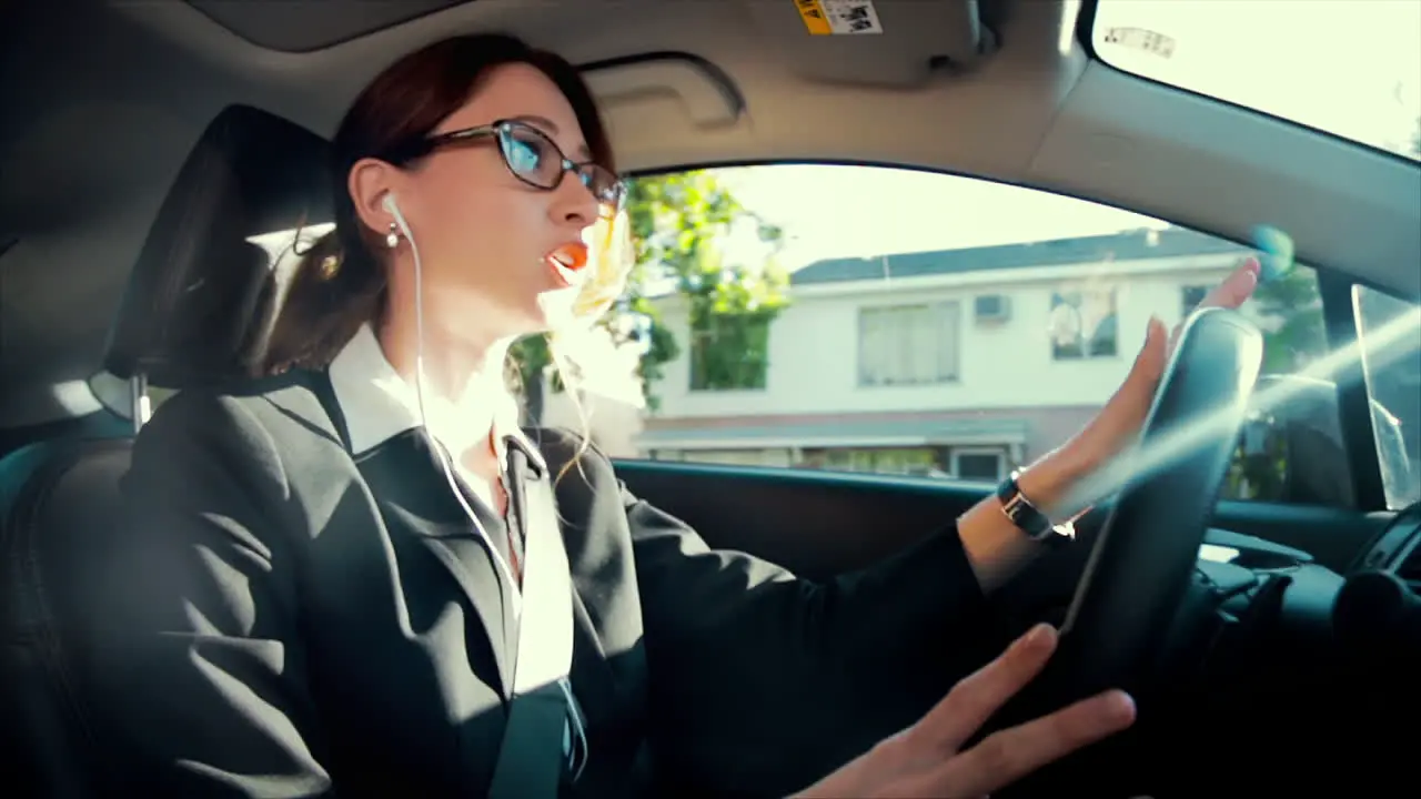 Attractive caucasian business woman is driving while talking on the phone she concentrates on this serious business call