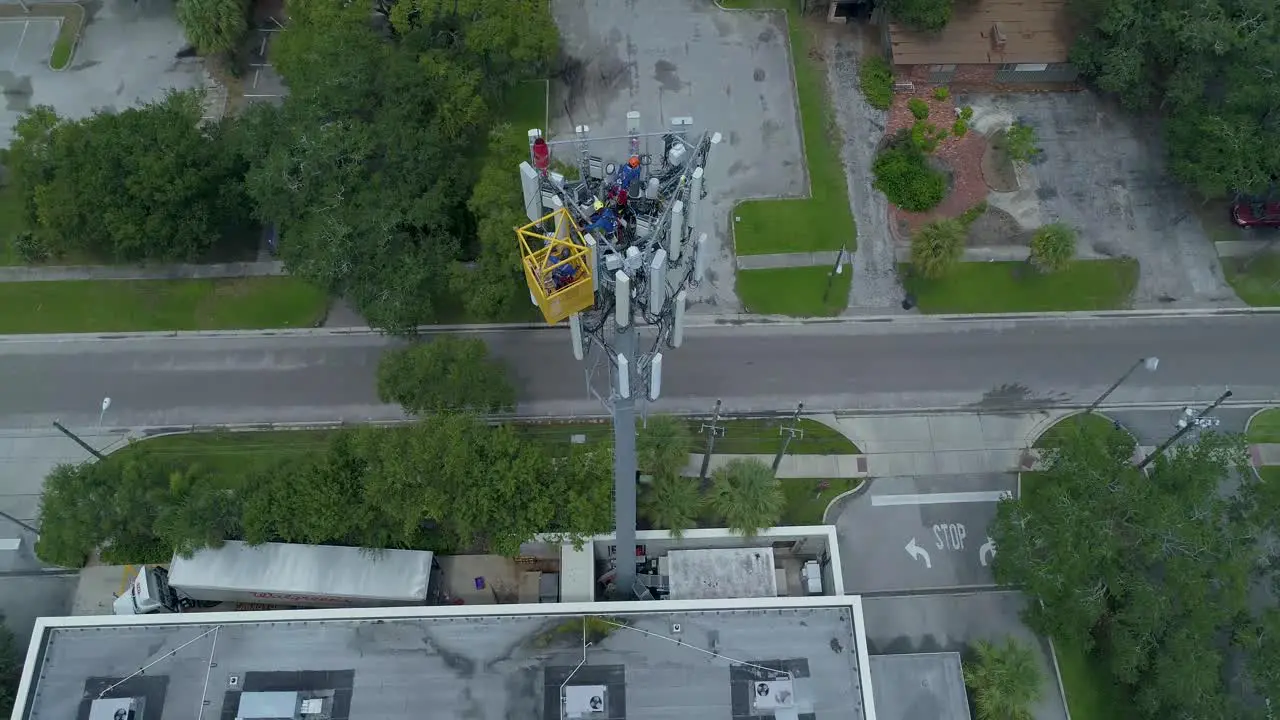 4K Aerial video of tower workers on cellular tower