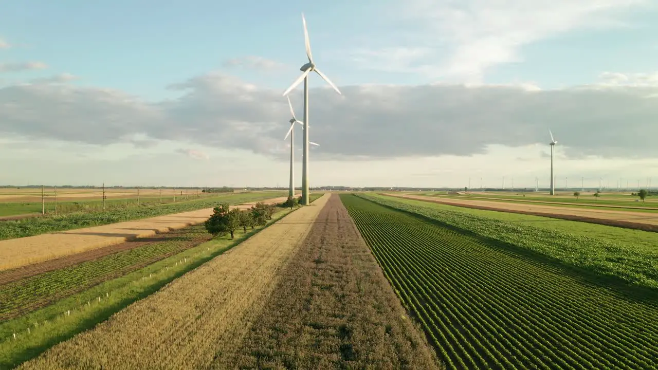 Aerial ascending view of wind turbines on a field 