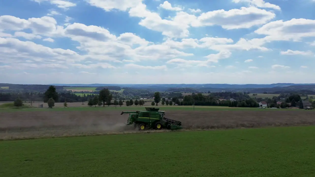 A view of the combined harvest in action where the camera rotates around the harvesting machine during work