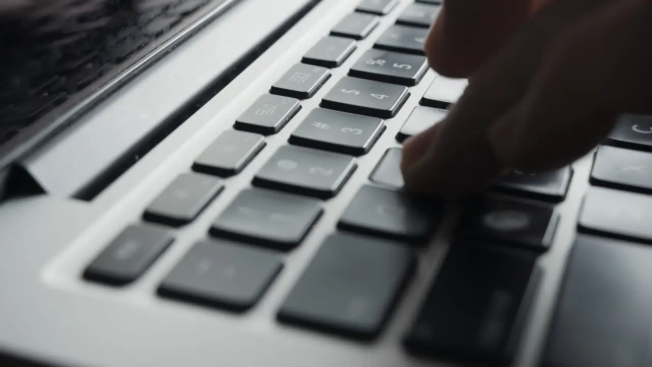 Laptop Keyboard Being Slid Into Position and Fingers Beginning to Type