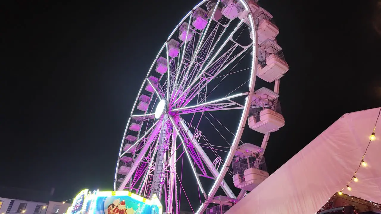 Winter fairgrounds Ferriswheel turning in night sky Waterford City Ireland