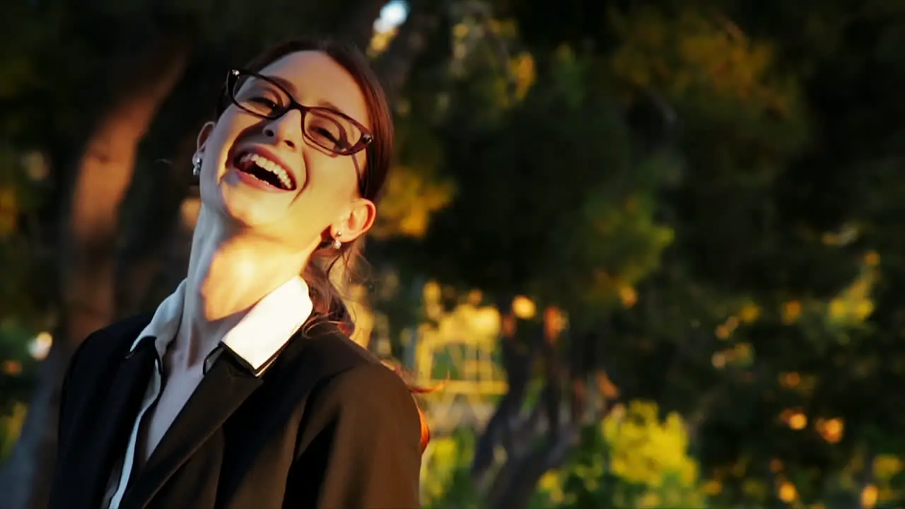 Attractive caucasian business woman looks at the camera while smiling and laughing