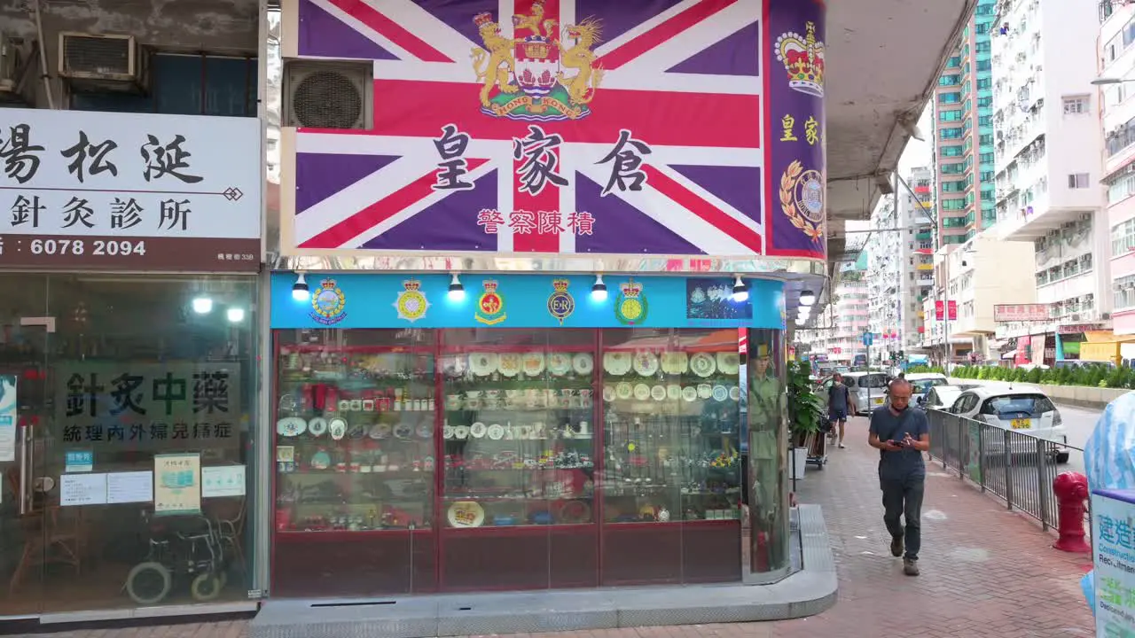 Pedestrians walk past a gift and ornament shop selling Britain colonial theme products and goods in Hong Kong