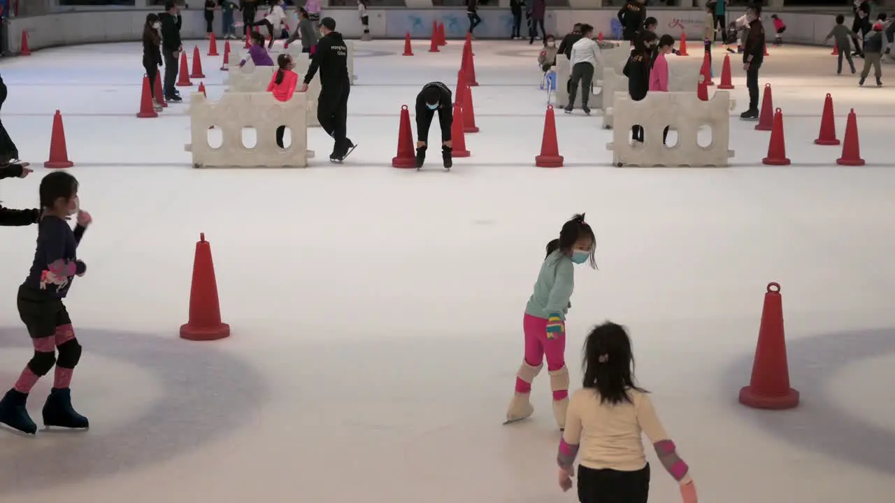 People of all ages are seen enjoying indoor ice skating at a shopping mall in Hong Kong