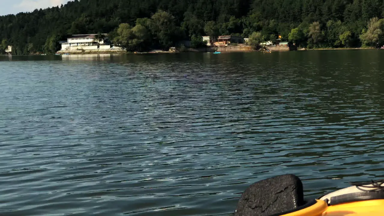 Reveal sho of the Pancharevo Lake  with a camera tilt starting from the bottom and a kayak berthed on a pier