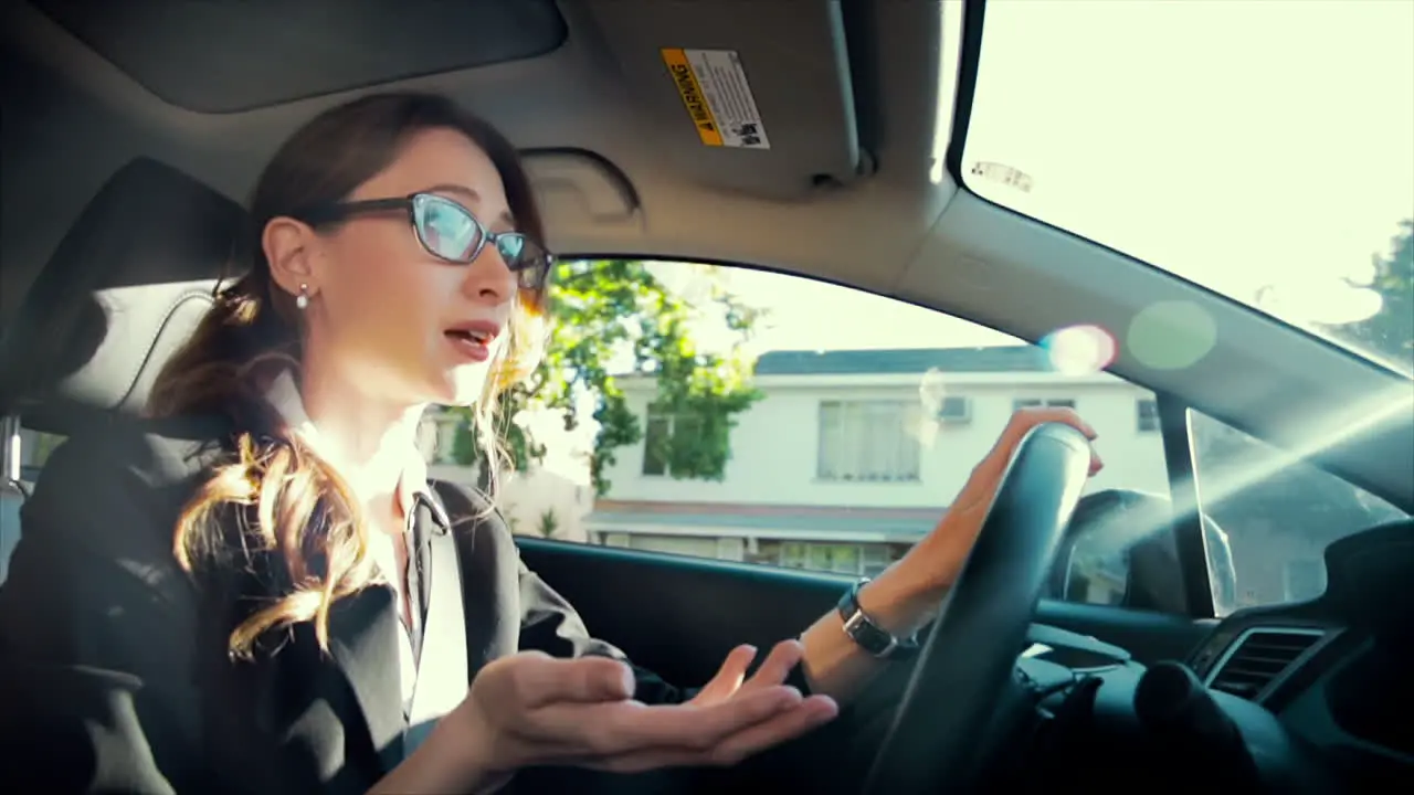 Business woman driving while talking on the phone