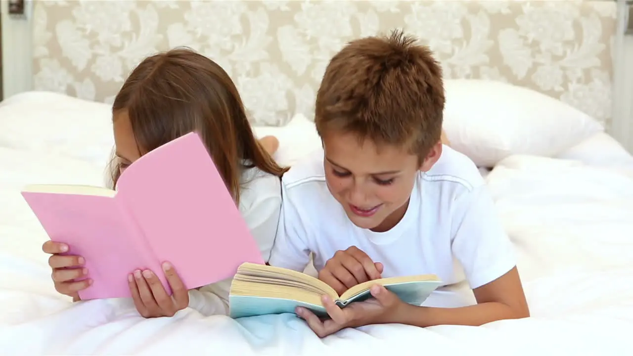  Children reading a book on the bed