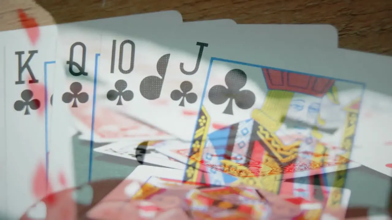 Cards game on wooden table with chips and cards on the foreground