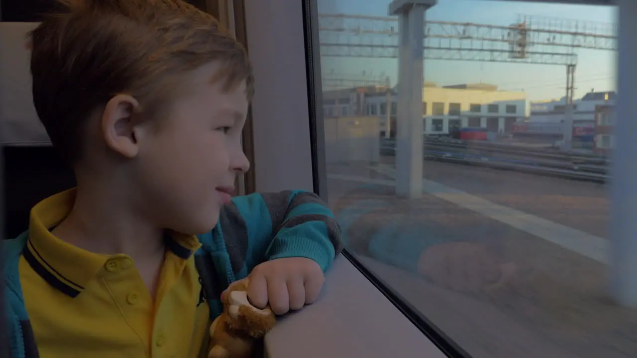 In Saint-Petersburg Russia in train rides a little boy who looks out the window and holding a toy