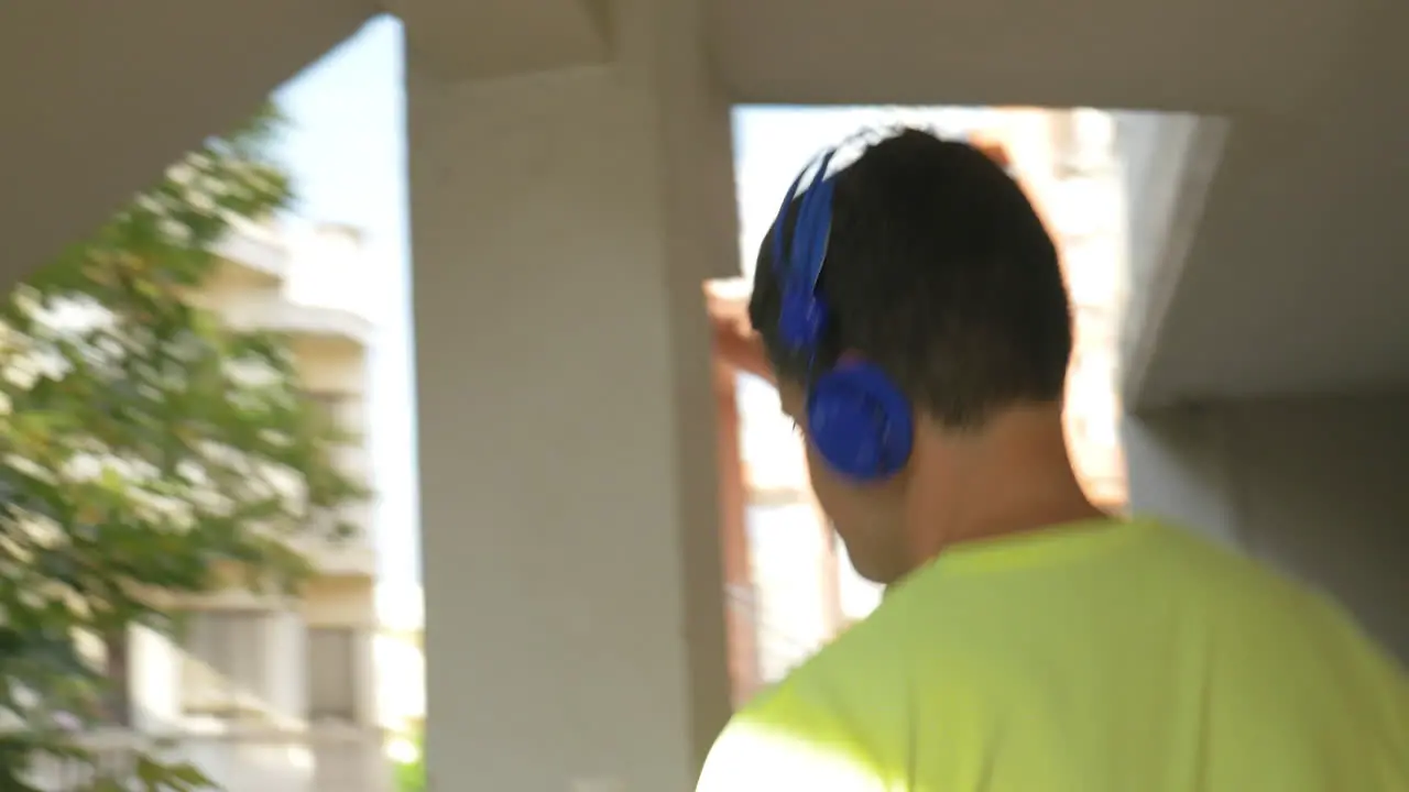 Man in headphones walking downstairs