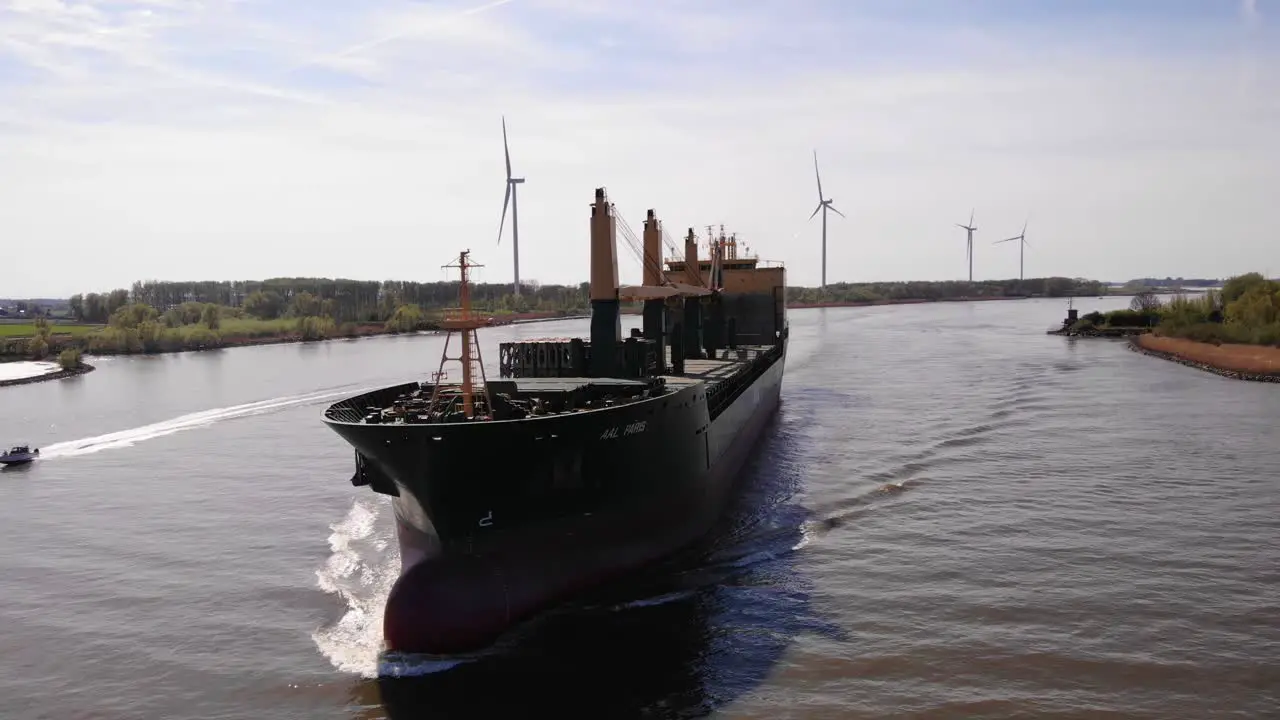 Aerial Circle Dolly Around Forward Bow Of Aal Paris Cargo Ship Travelling Along Oude Maas On Sunny Day