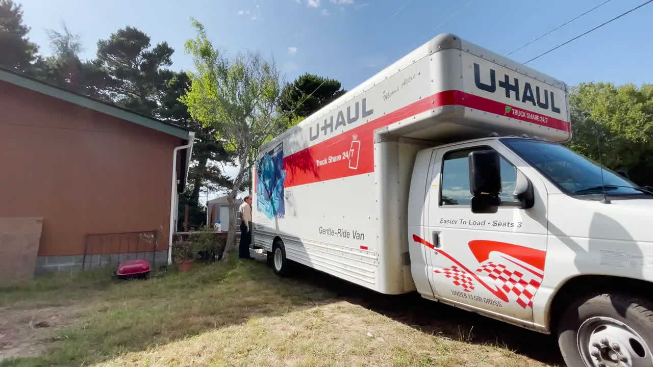 U-Haul truck parked next to a home waiting to be unloaded after a move