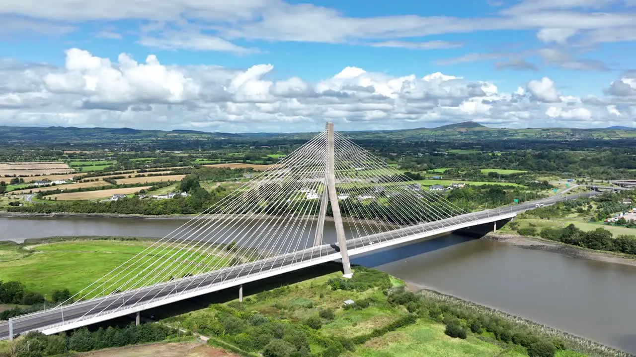 Drone flying towards suspension bridge in Waterford Ireland on a summer day