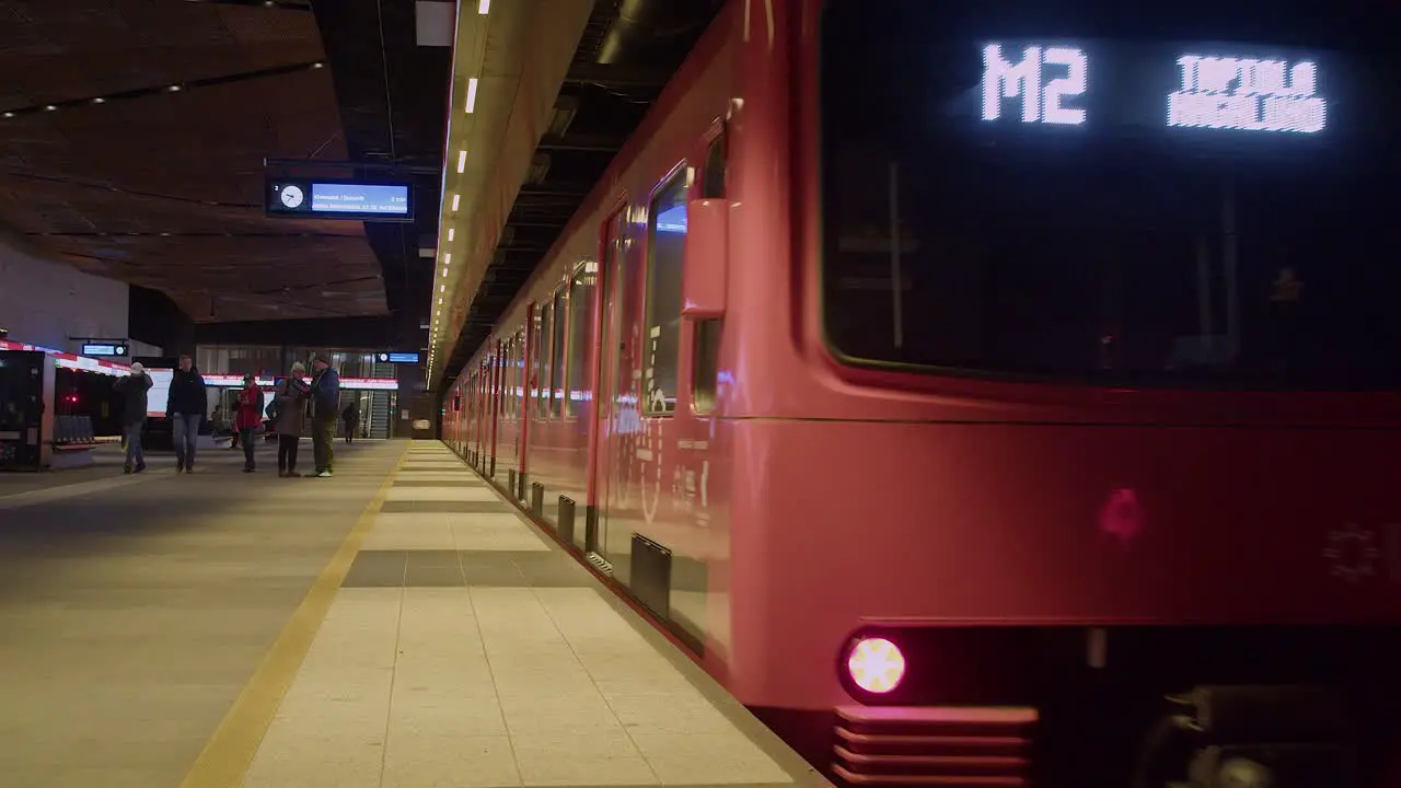 Doors close and transit train in underground subway station departs