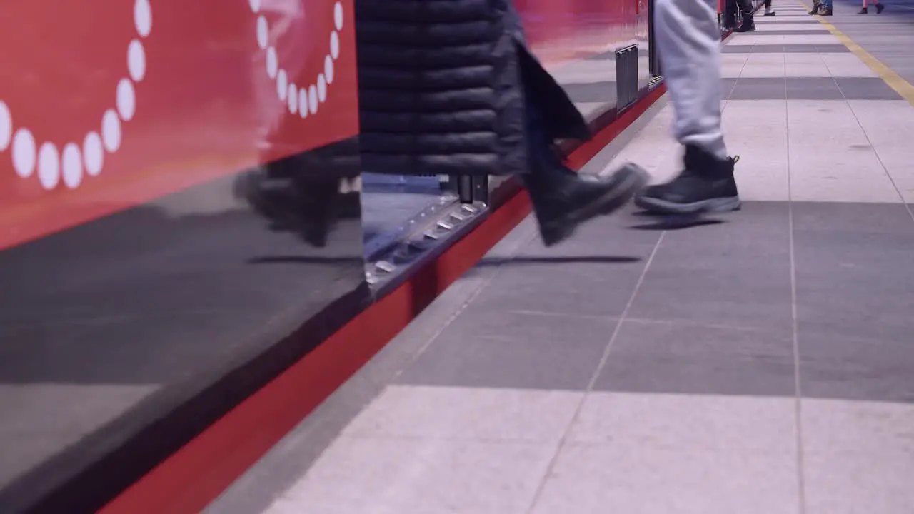 Red transit train arrives at Helsinki subway station passengers board