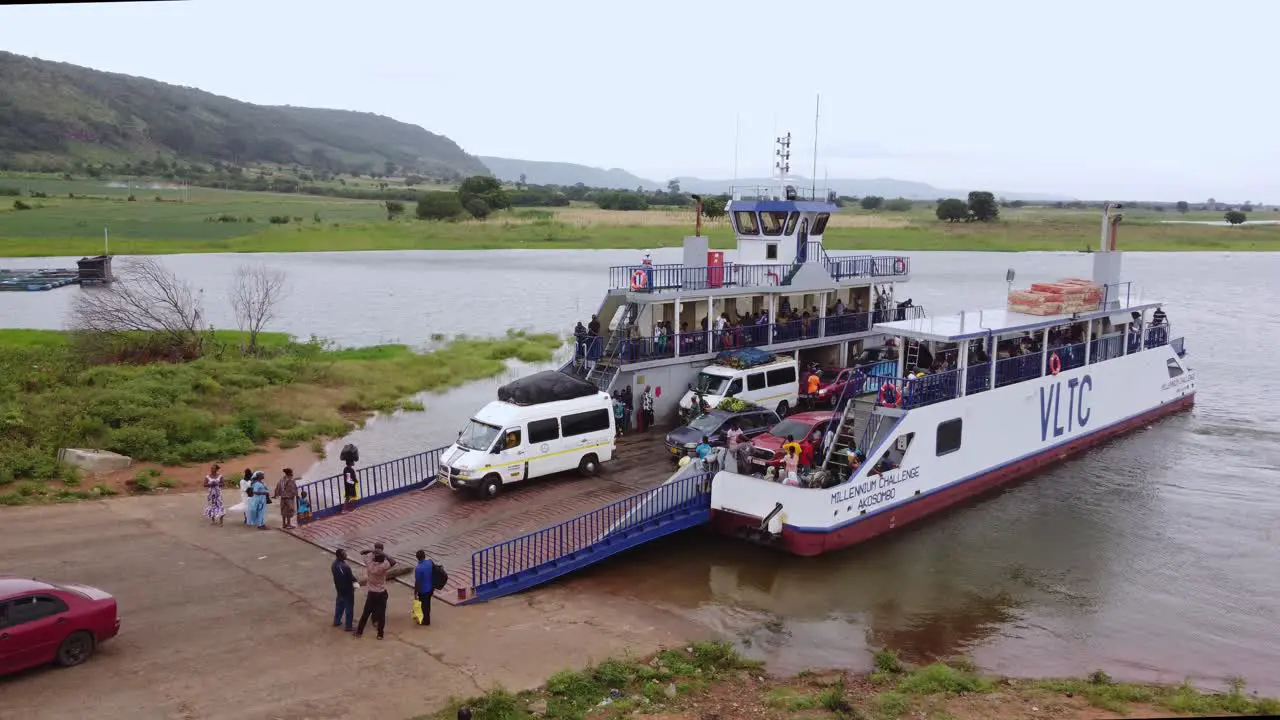 Passengers and Vehicles Board Cargo Barge to Travel on River Afram in Ghana