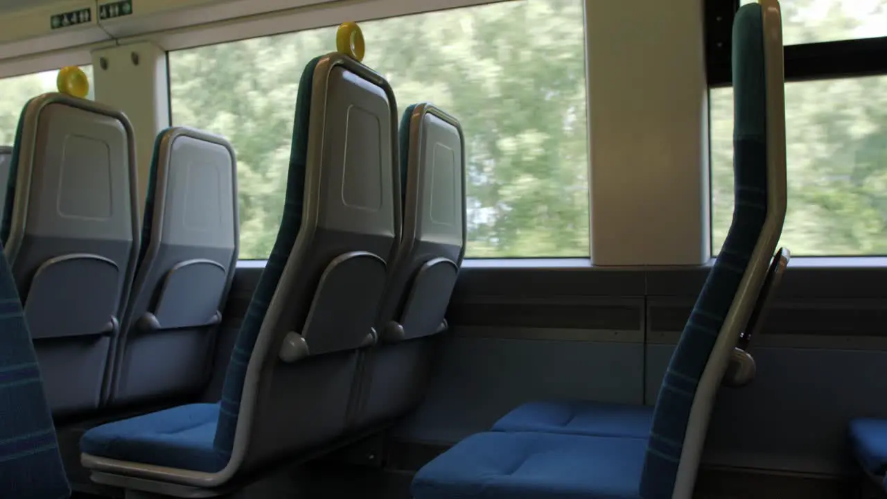 Empty seats on a british train as it travells through the countryside