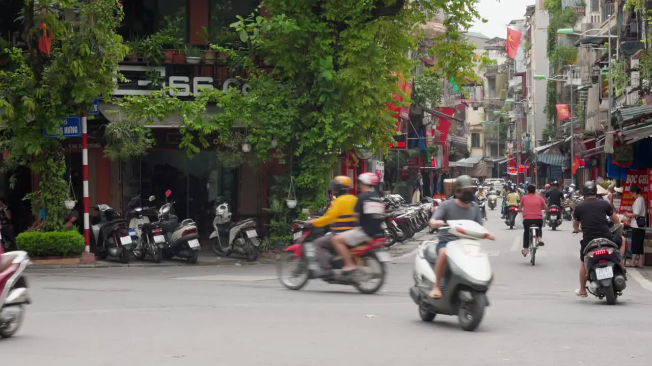 Typical Vietnam day street scene motorcycle traffic at intersection Hanoi