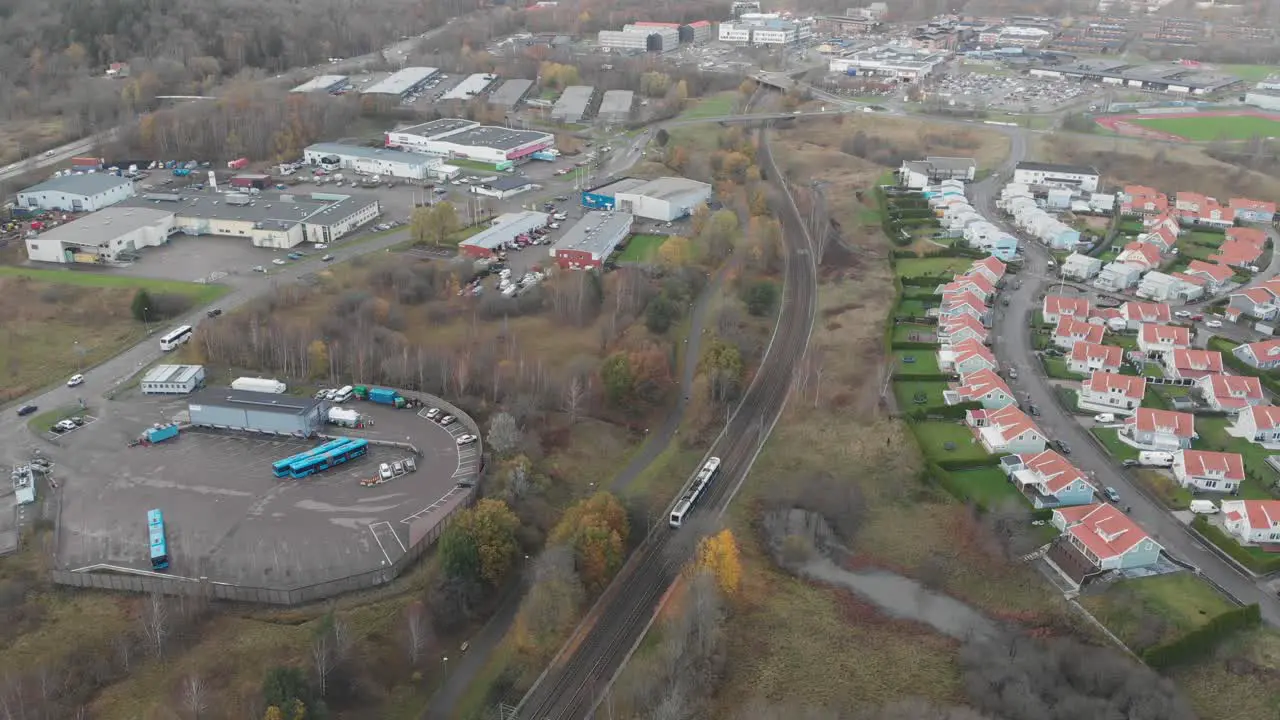 Wide aerial view of a tram traveling through suburban Gothenburg Sweden