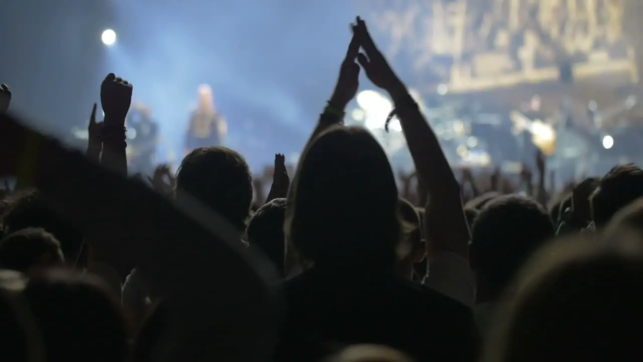 Crowd claping hands on the pop concert