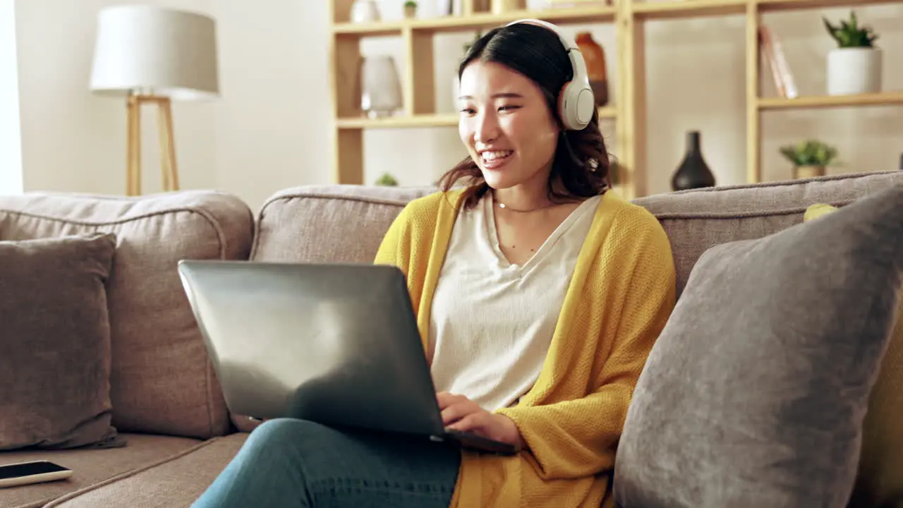 Laptop sofa and Asian woman relax with headphones