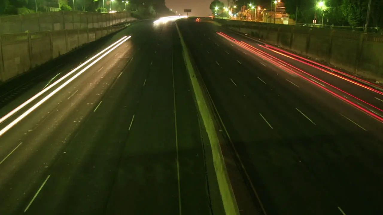 Traffic drives along a freeway at night