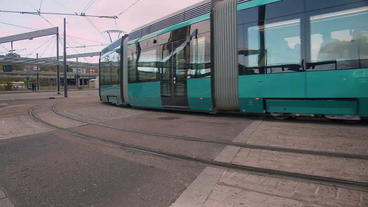 Shiny new public transit street tram turns corner in Helsinki Finland